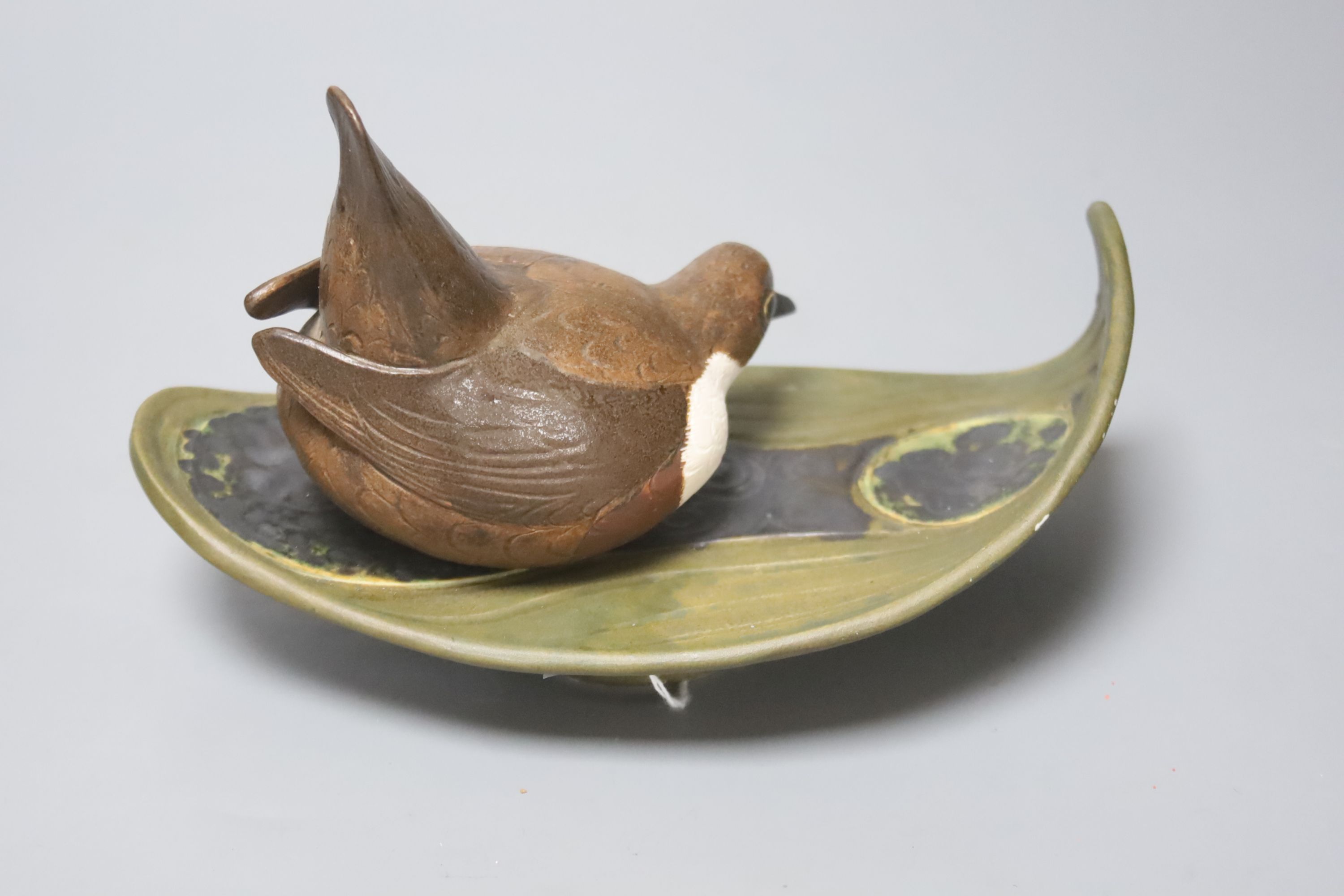 A Norman Makinson Studio pottery 'bird on leaf', length 23cm